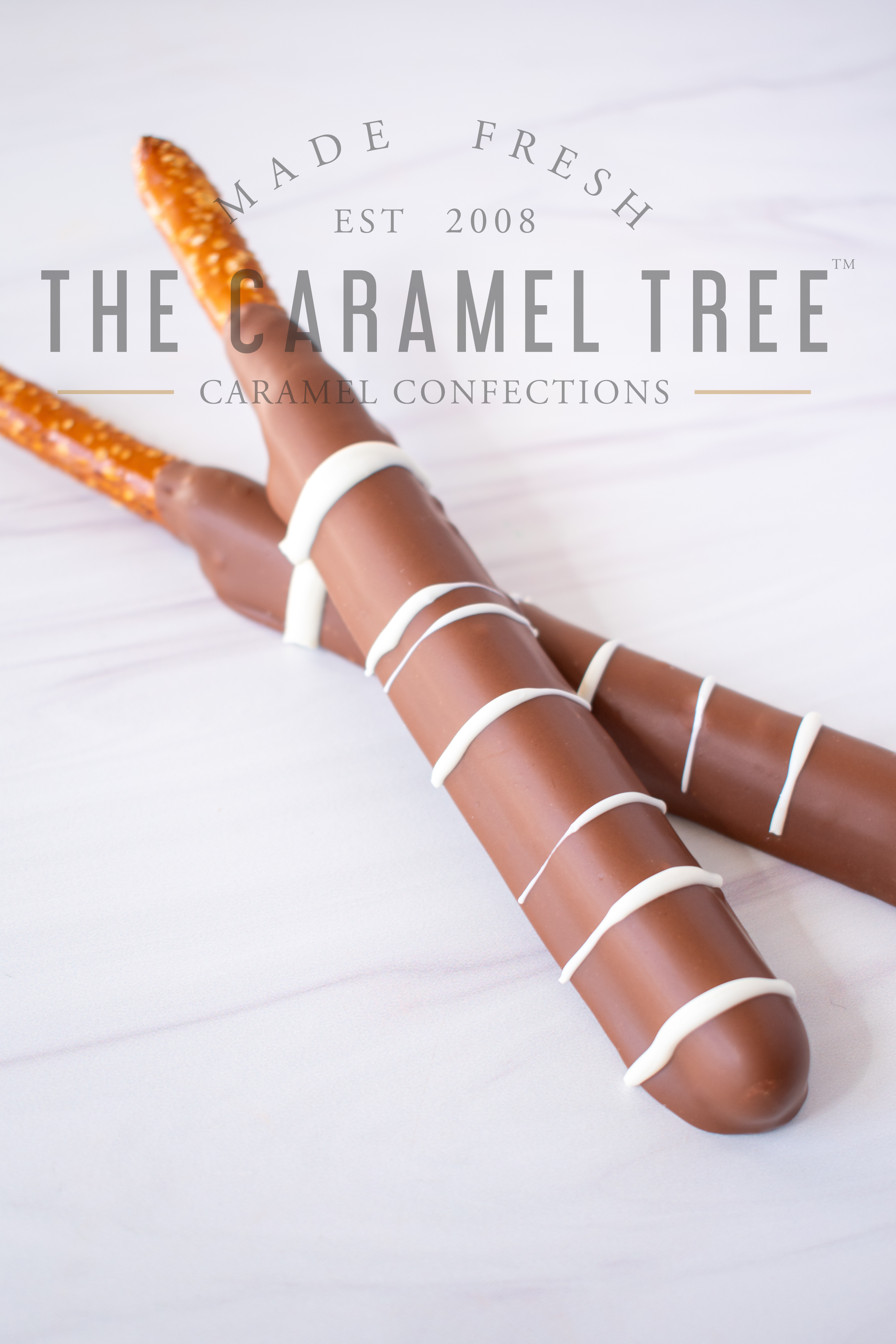 caramel and chocolate dipped pretzel rods milk with logo